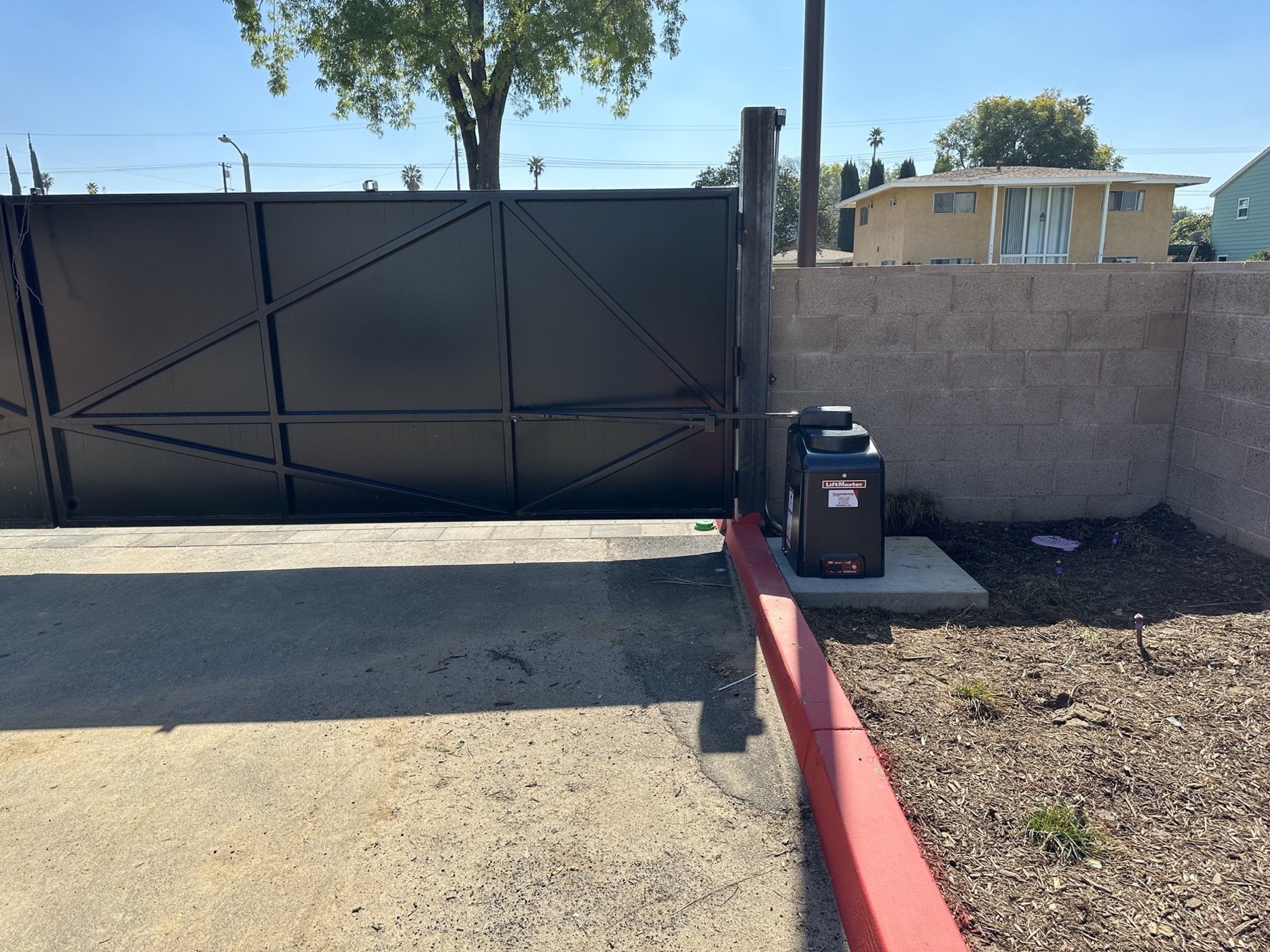 LiftMaster gate operator installed beside an existing sliding gate